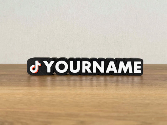 A 3D Printed Name Sign In TikTok Style On a Worktop