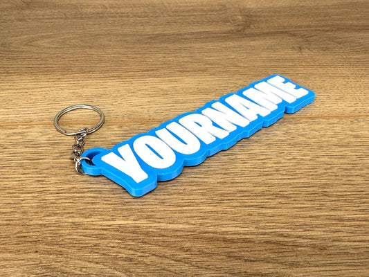 picture of a gift keyring or bag tag in the battle royale video game fortnite style on a wooden worktop