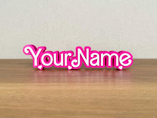 Picture of a barbie doll name sign on a wooden desk or bedroom table