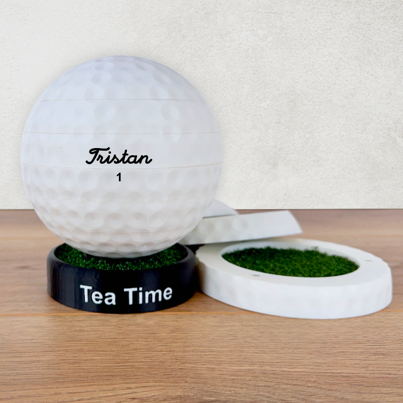 A picture of 4 drinks coasters in the shape of a golf ball, with artificial grass inserts on a wooden work surface