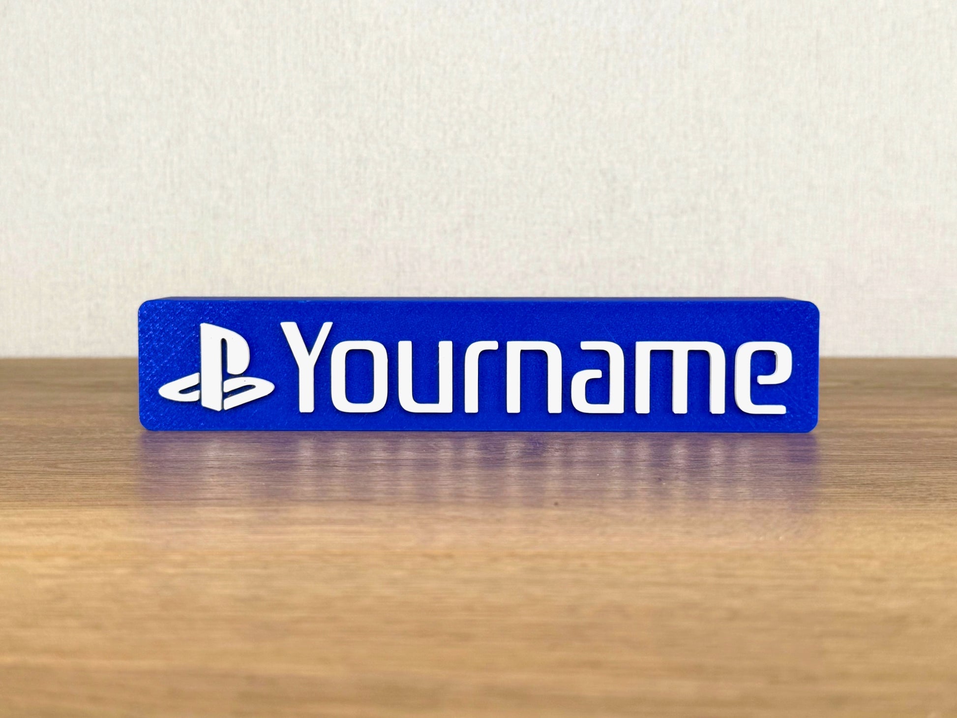 Picture of a Sony playstation video game name sign on a desk or bedroom table