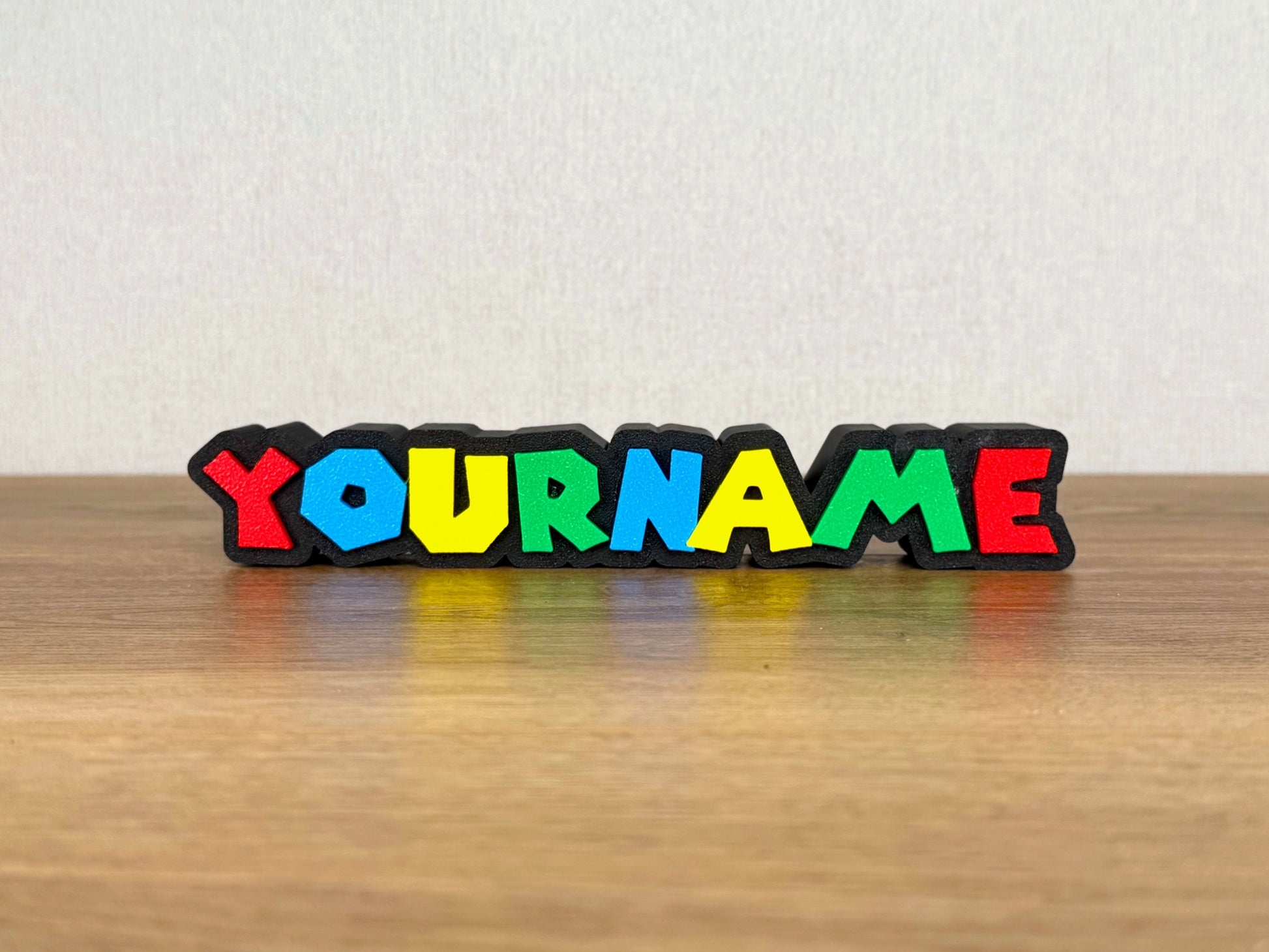 Picture of a super mario nintendo video game name sign on a desk or bedroom table