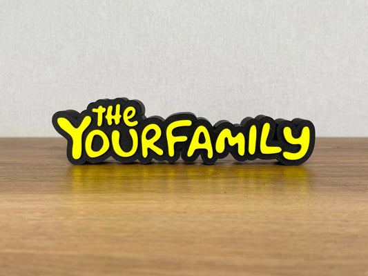 Picture of a the Simpsons family name sign on a wooden desk or bedroom table