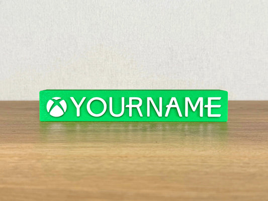 Picture of an xbox video game name sign on a wooden desk or bedroom table