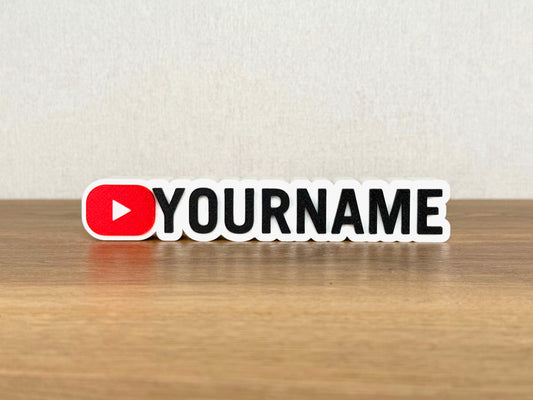 Picture of a YouTube influencer or content creator name sign on a wooden desk or bedroom table