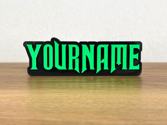 Picture of a wicked musical name sign on a wooden desk or bedroom table